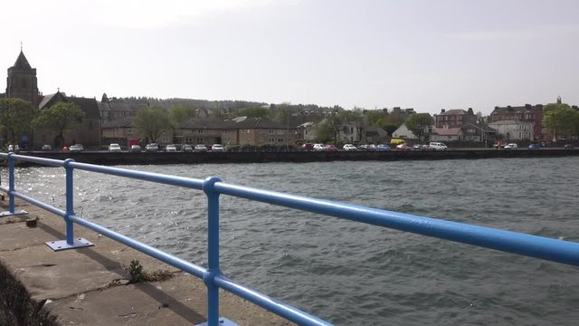 Choppy waters of the River Clyde on a windy day crashing against the esplanade wall at Greenock.