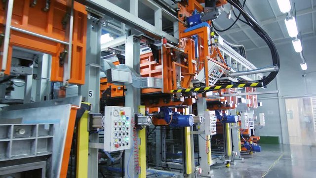 production line with equipment and control panels in shop