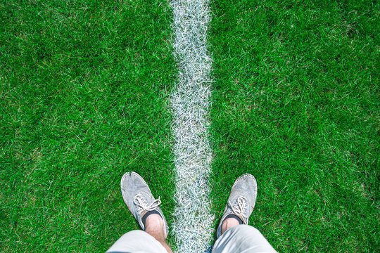 person stand in grass