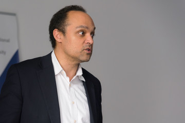 Young african american businessman at business conference room with public giving presentations. Audience at the conference hall. Entrepreneurship club.