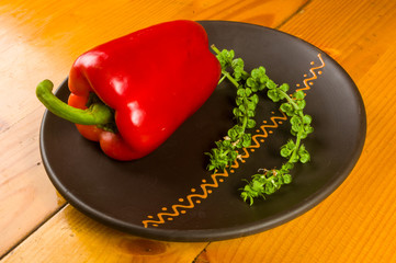 a freshest red paprika, bell pepper in ceramic plate