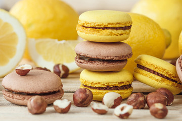 Yellow and brown french macarons with lemon and hazelnuts