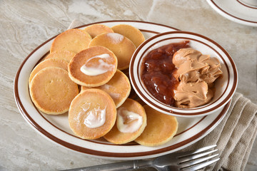 Mini pancakes with peanut butter and jam