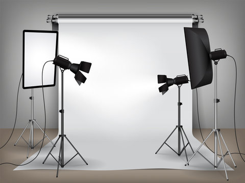 Realistic photo studio set up with lighting equipment and white backdrop