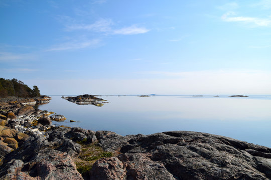 Early morning in the Swedish archipelago with tranquil water and no people around. The island -and national park - "Blå jungfrun" can be seen far away in the horizon