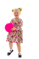 Little girl is playing with a ball
