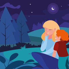 beautiful mother with son in the landscape at night