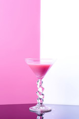 martini glass on white and pink background