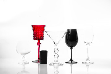 Set of empty glasses for different alcohol drinks and cocktails isolated on white background