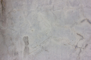 Spring green grass over white concrete wall background