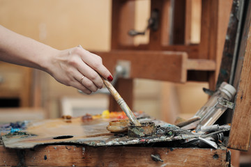 Brushes in the hands of the artist's women. Drawing and art.