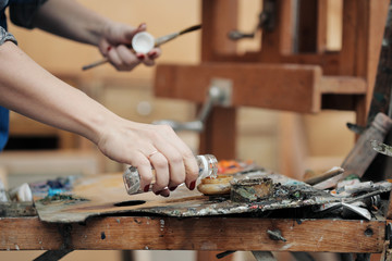 Brushes in the hands of the artist's women. Drawing and art.