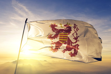 Limburg province of Belgium flag waving on the top sunrise mist fog