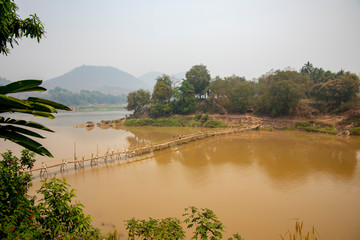 Bamboo bridge over Nam Khan River at confluence of Mekong River Laos