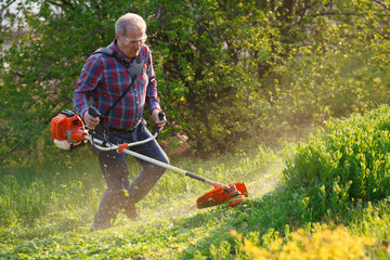 man mows the lawn grass with a lawn mower
