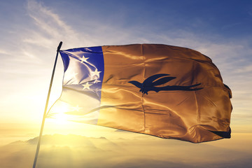 New Ireland province of Papua New Guinea flag waving on the top sunrise mist fog