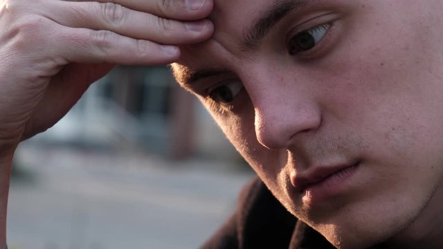 Sad guy scratching his forehead and doesn&rsquo;t know what to do