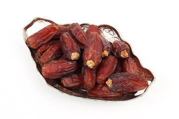 Islamic festival of Ramadan concept. with a delicious tropical dates on a silver plate and on white isolated background. Traditional Middle East culture. Ramadan Kareem.