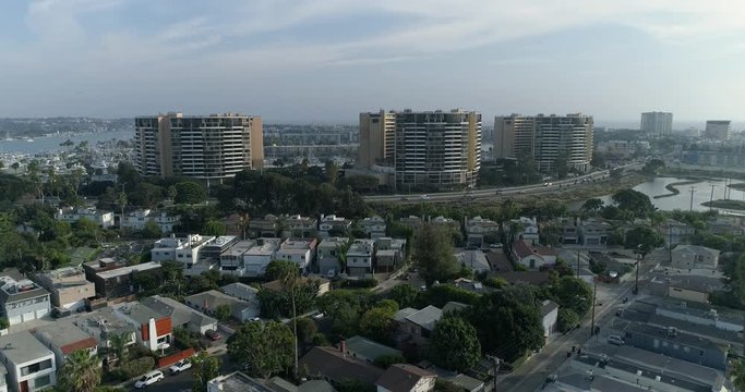 Aerial of Marina Del Rey (Venice area).  Crane visual in SLOW Motion. Unique Buildings, canals, water, streams, beach, mountains, ocean, sea, shore, coastline, cityscape, Venice Beach, Califor