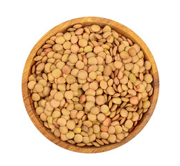 green lentil in wooden bowl isolated on white background. Top view