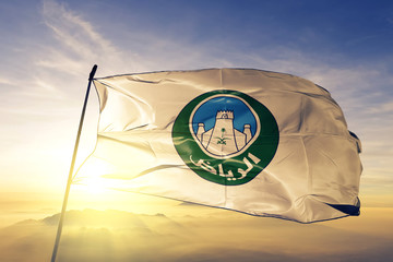 Riyadh City flag waving on the top sunrise mist fog