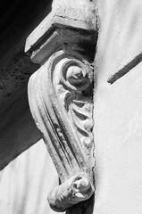 Stone carved corbel under the window of an old building- а black-white picture. © Тамара Селиванова