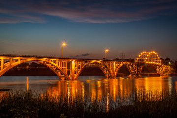 The bridge over the Arkansas River at Ozark Arkansas at dusk with the lights on