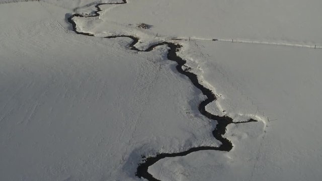 Aerial view of winding river and tree in snow / Wallsburg, Utah, United States