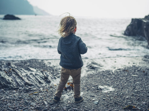 Toddler standing on the beach