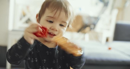 Cute baby girl playing with toys. Shot on a cinema camera. 4K.