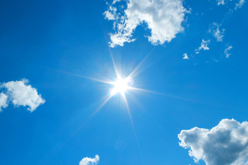 Sunshine in blue sky with white clouds