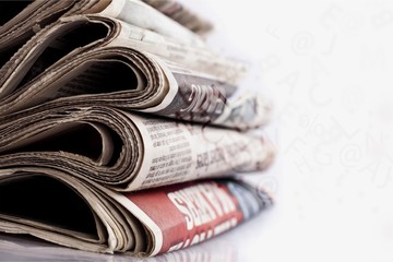 Pile of newspapers on white background