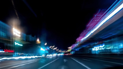 Fototapeta na wymiar Fast car trip time lapse on the highway by night seen from the car