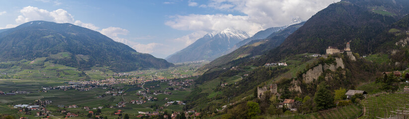 Fototapeta premium Panorama of Tyrol Castle with Castle Brunnenburg inside Valley and Alps of Meran. Tirol Village, Province Bolzano, South Tyrol, Italy.