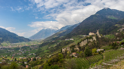 Obraz premium Panoramic view on Tyrol Castle with Castle Brunnenburg inside Valley and Alps of Meran. Tirol Village, Province Bolzano, South Tyrol, Italy.