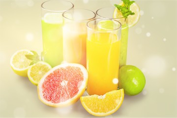 Tasty fruits  and juice with vitamins on background