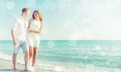 Beach couple walking on romantic travel honeymoon vacation summer holidays romance. Young happy lovers, Asian woman and Caucasian man holding hands embracing outdoors