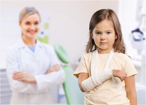 Sad Little girl with broken arm at doctor