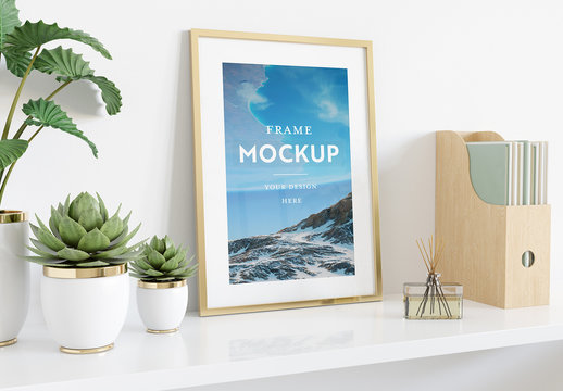 
Vertical Frame Leaning on Shelf With Plants and Books Mockup