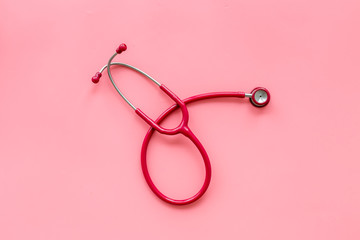 Fototapeta premium diagnostic and cure of cardiac disease with stethoscope on pink background top view