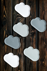 Fototapeta premium cloud service concept with clouds on wooden background top view