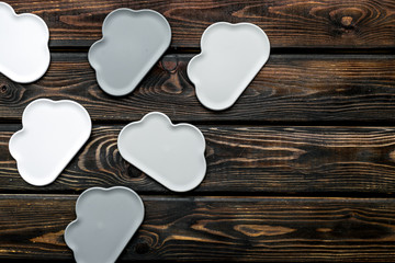 cloud service concept with clouds on wooden background top view copy space