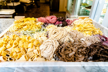 Different types of colorful original Italian pasta.
