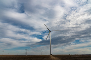 Wind Turbines in Field with Blue Sky and Puffy Clouds