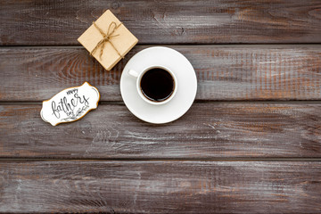 cup of coffee, gift and copy for Happy Father Day party on wooden background top view copy space