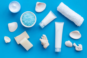 cosmetics with Dead Sea minerals and shells on blue background top view