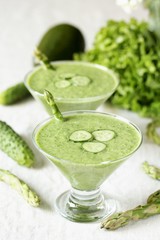 soup puree from avocado, asparagus and cucumber. Dietary detox diet. Vegetarian dish. serving soup in a glass bowl.