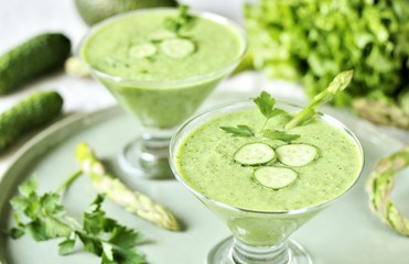 soup puree from avocado, asparagus and cucumber. Dietary detox diet. Vegetarian dish. serving soup in a glass bowl.