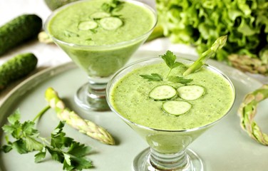 soup puree from avocado, asparagus and cucumber. Dietary detox diet. Vegetarian dish. serving soup in a glass bowl.