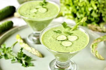 soup puree from avocado, asparagus and cucumber. Dietary detox diet. Vegetarian dish. serving soup in a glass bowl.